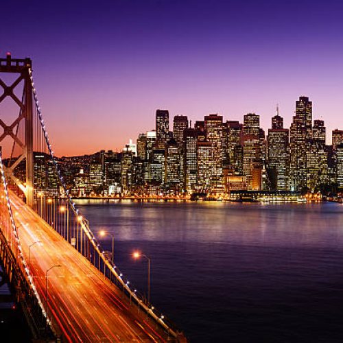 San Francisco skyline and Bay Bridge at sunset, California
